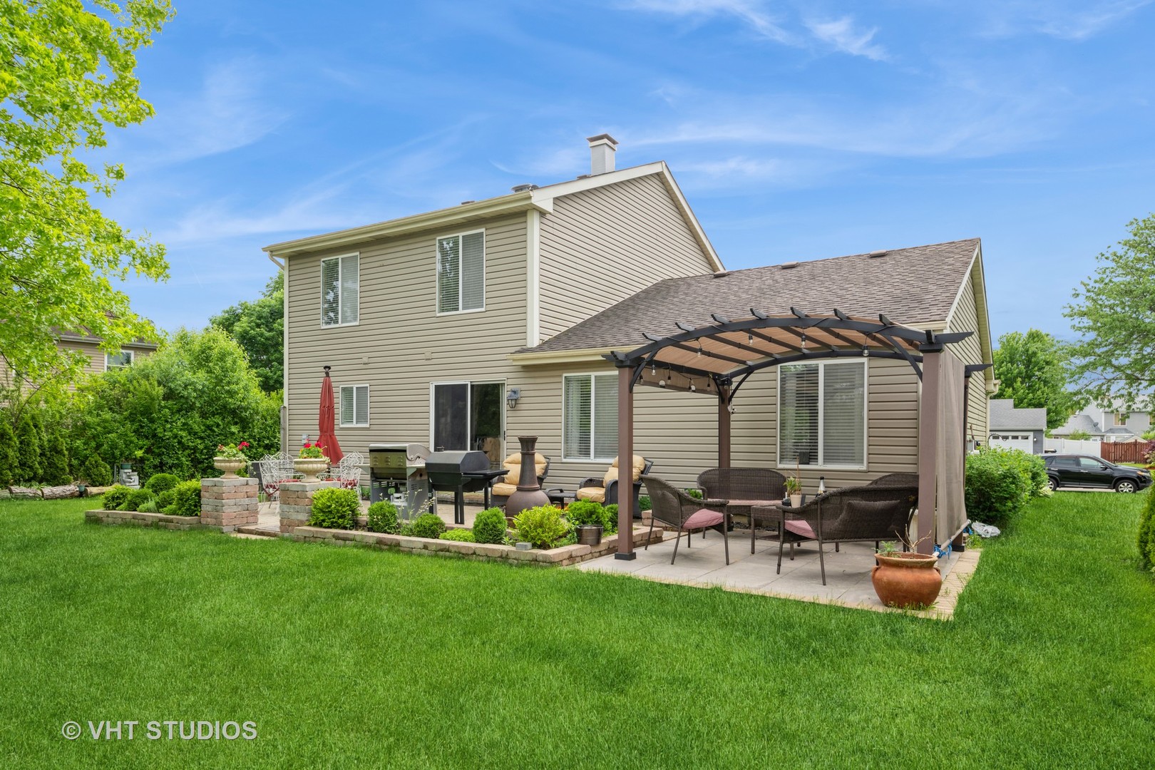 1026 Longford Road Bartlett, IL 60103 - Photo 20 of 24 a backyard of a house with table and chairs