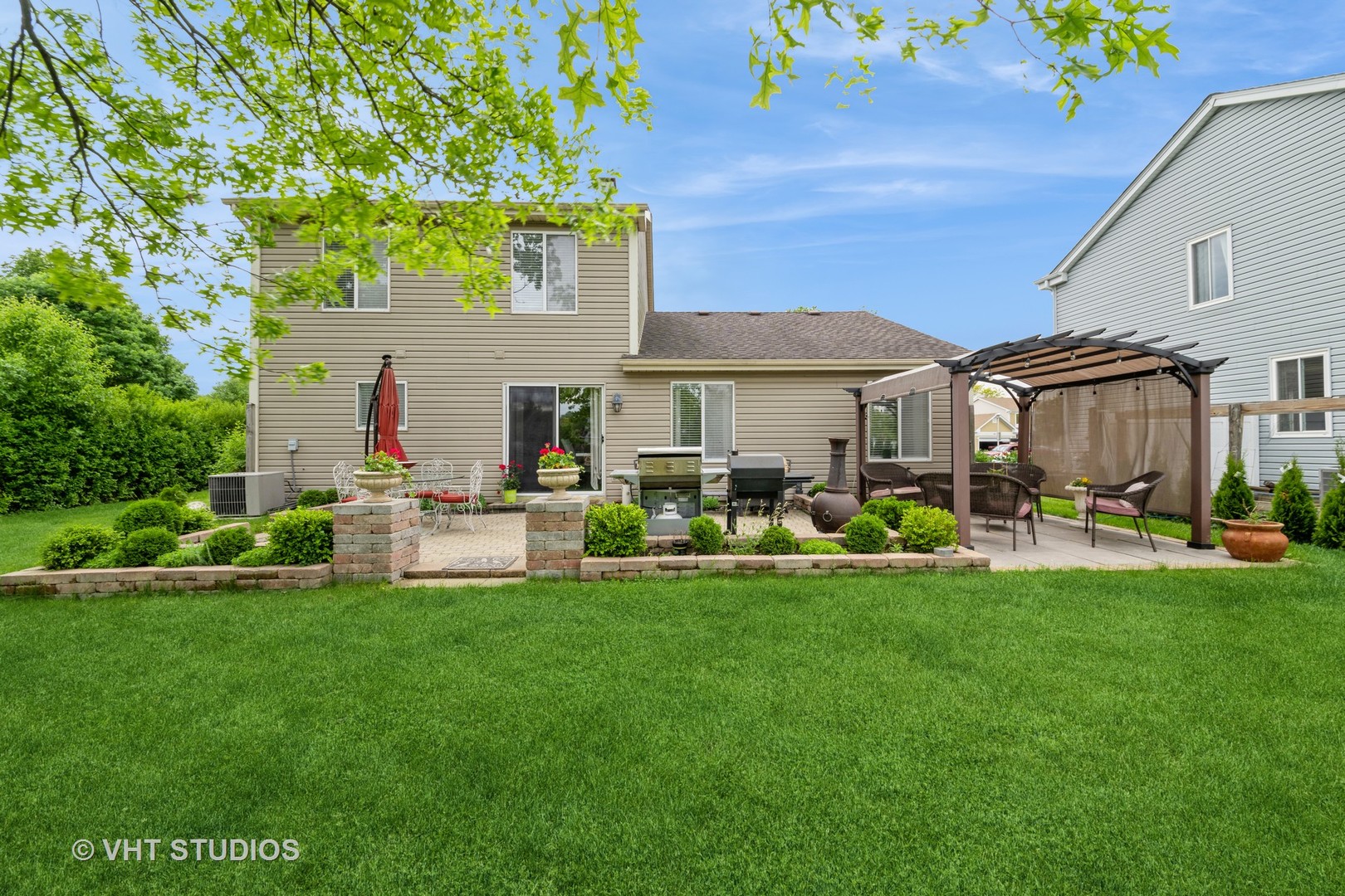 1026 Longford Road Bartlett, IL 60103 - Photo 21 of 24 a view of a house with backyard porch and sitting area