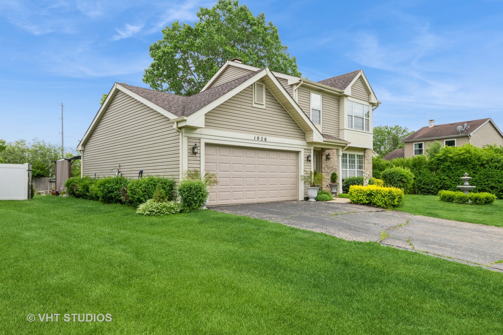 1026 Longford Road Bartlett, IL 60103 - Photo 23 of 24 a view of a yard in front of a house with plants and large tree