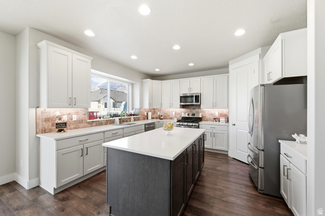 1434 West Stable Street Lindon, UT 84042 - Photo 16 of 76 Kitchen featuring stainless steel appliances, a center island, dark wood-style floors, dual tone cabinetry, and recessed lighting
