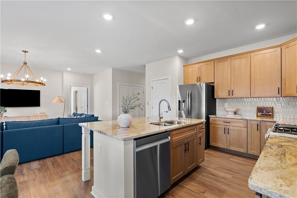229 Lola Court McKees Rocks, PA 15136 - Photo 14 of 23 a kitchen with stainless steel appliances granite countertop a sink stove and refrigerator