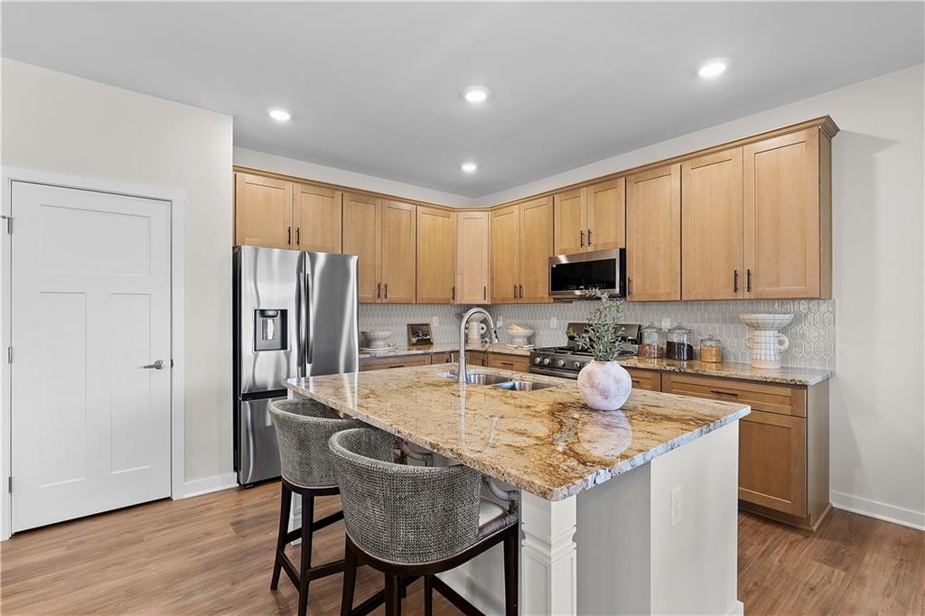 229 Lola Court McKees Rocks, PA 15136 - Photo 10 of 23 a kitchen with refrigerator cabinets dining table and chairs
