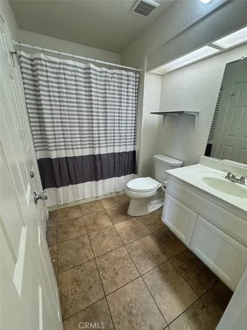 a bathroom with a sink toilet and mirror