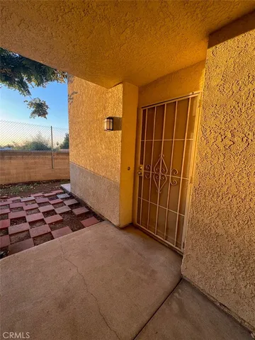 an empty room with sliding door and wooden floor