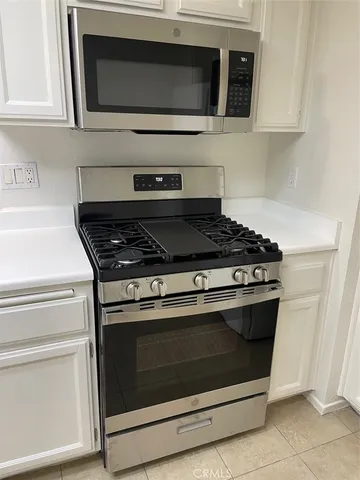 a view of a room with wooden floor and a window
