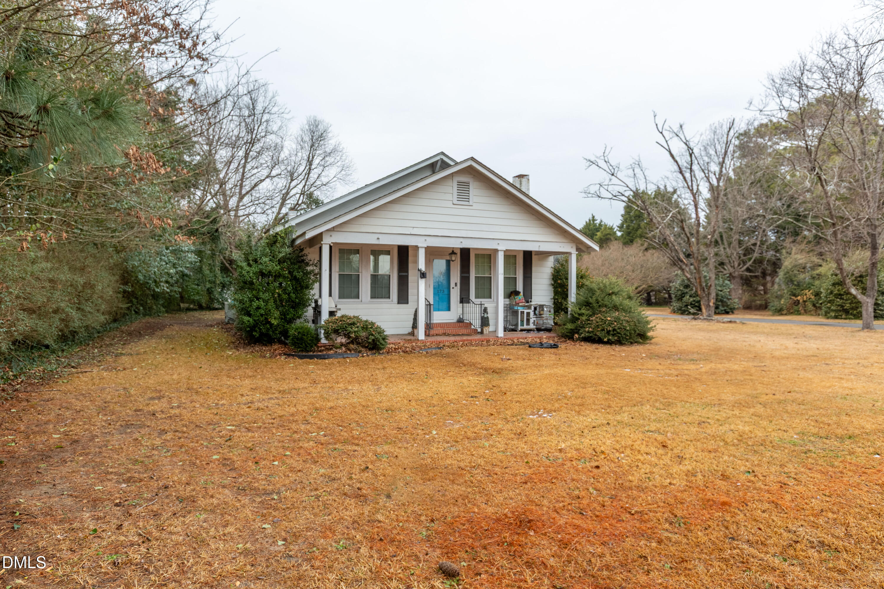 a front view of a house with yard and green space