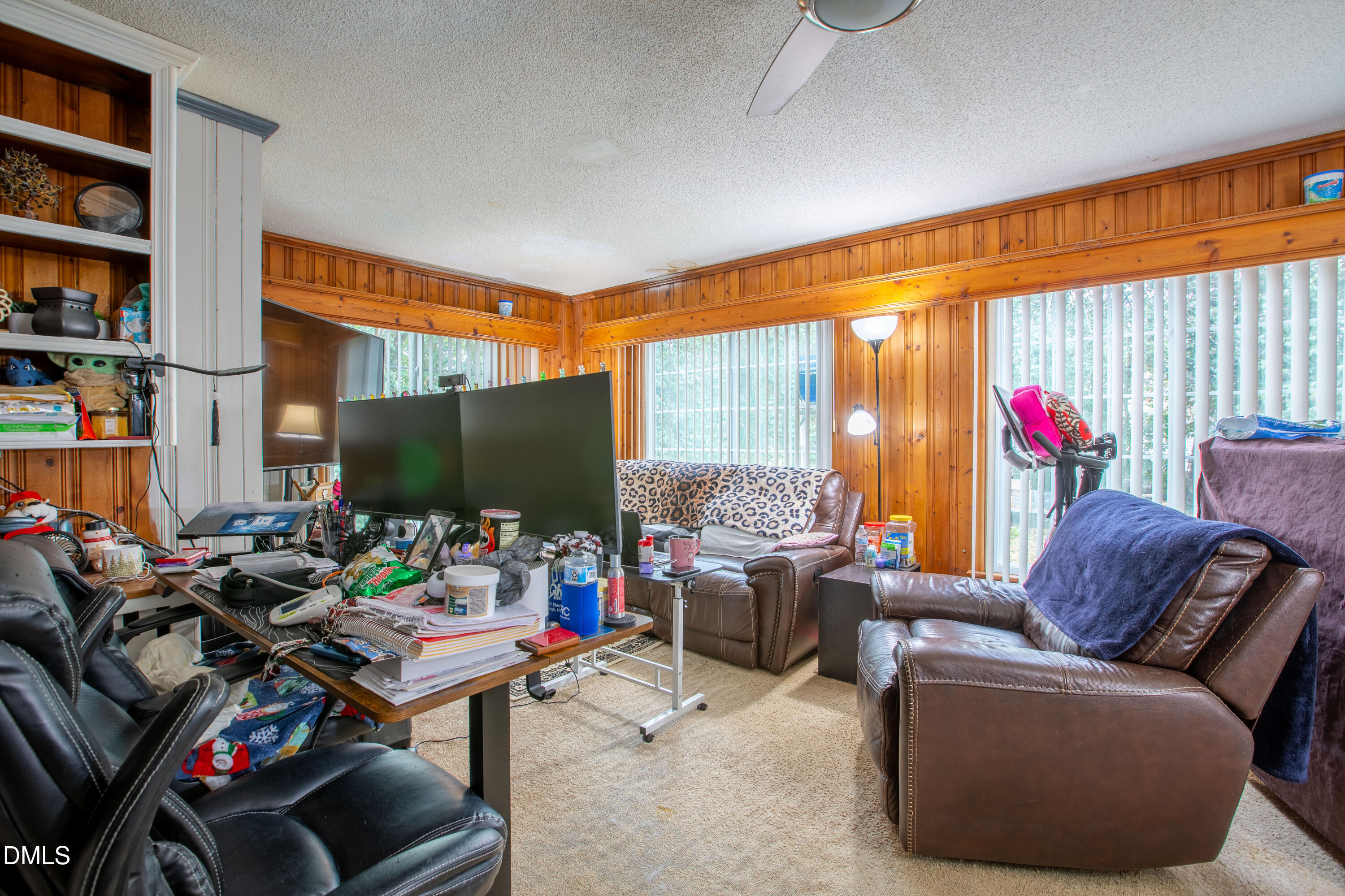 173 Jernigan Road Dunn, NC 28334 - Photo 11 of 42 a living room with furniture a flat screen tv and a fireplace