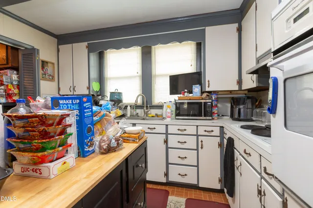 a kitchen with stainless steel appliances kitchen island granite countertop a sink and cabinets