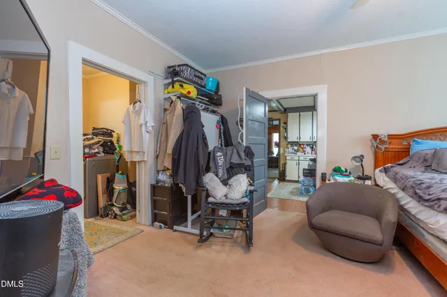 a living room with furniture and a gym machine