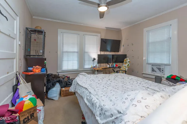 a bed room with a bed and a tv