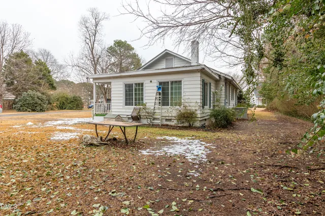 a front view of house with yard and trees around