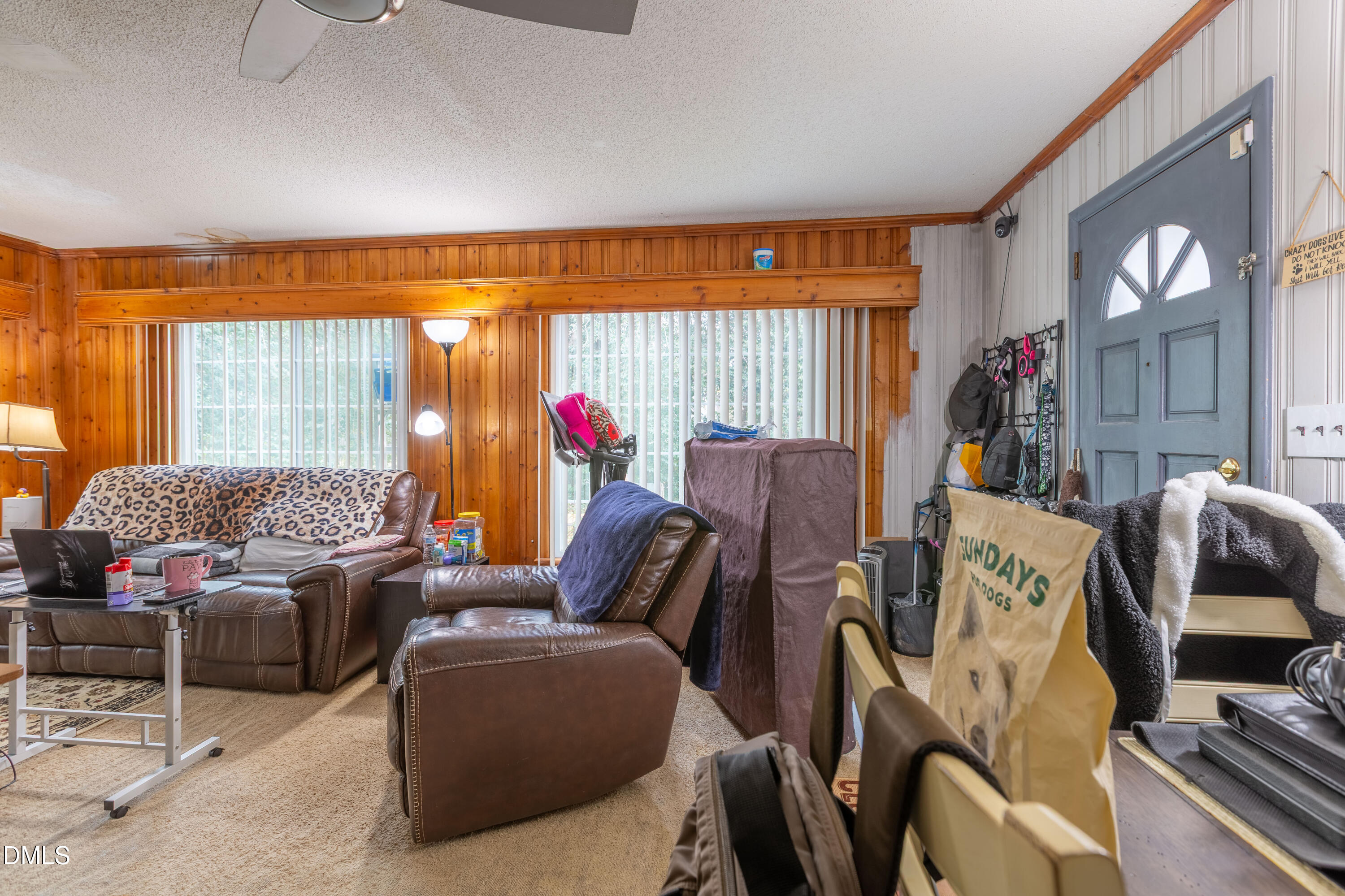 173 Jernigan Road Dunn, NC 28334 - Photo 10 of 42 a living room filled with furniture and a floor to ceiling window