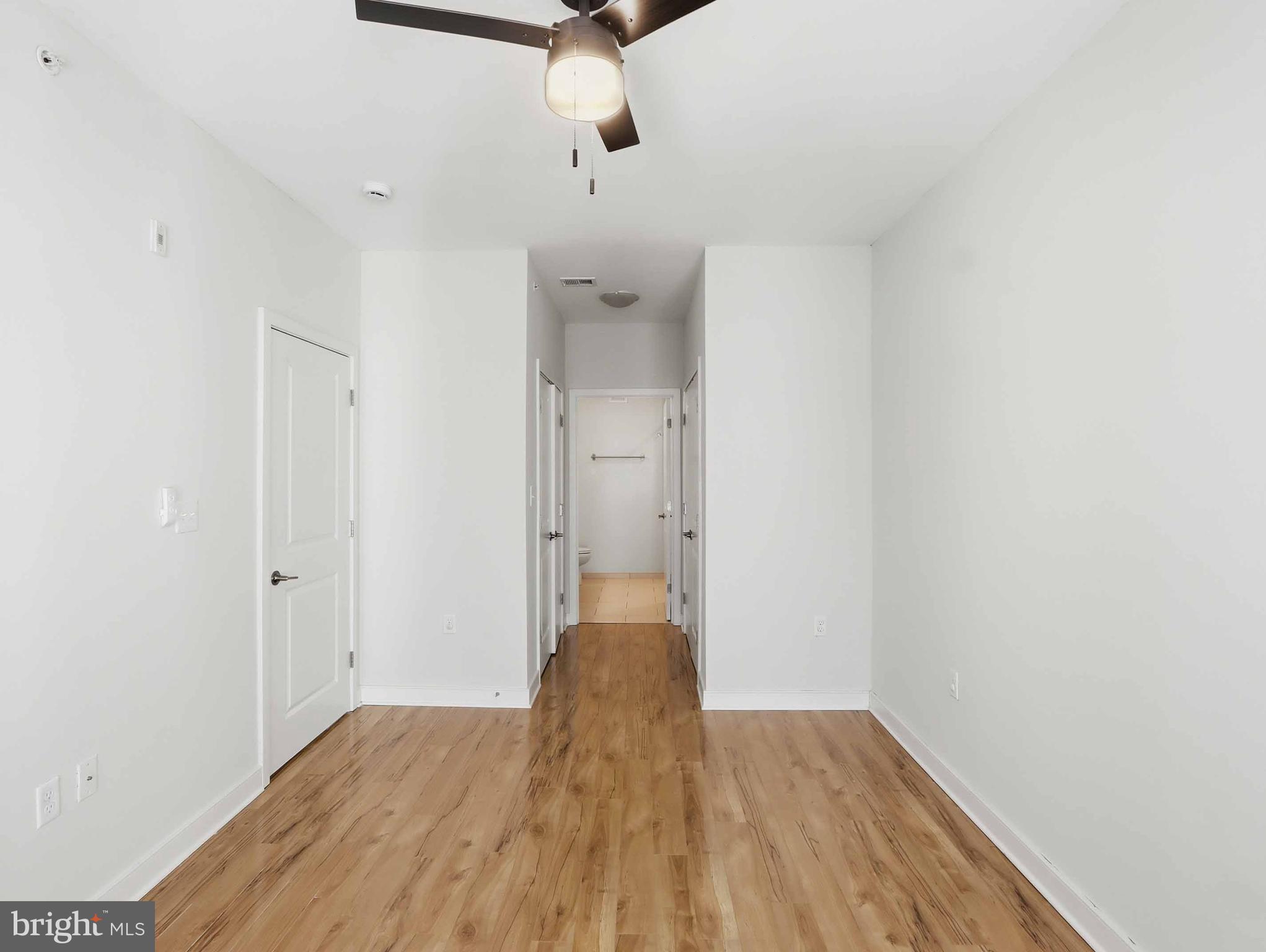 8005 13th Street, Unit 411 Silver Spring, MD 20910 - Photo 29 of 33 a view of an empty room with wooden floor