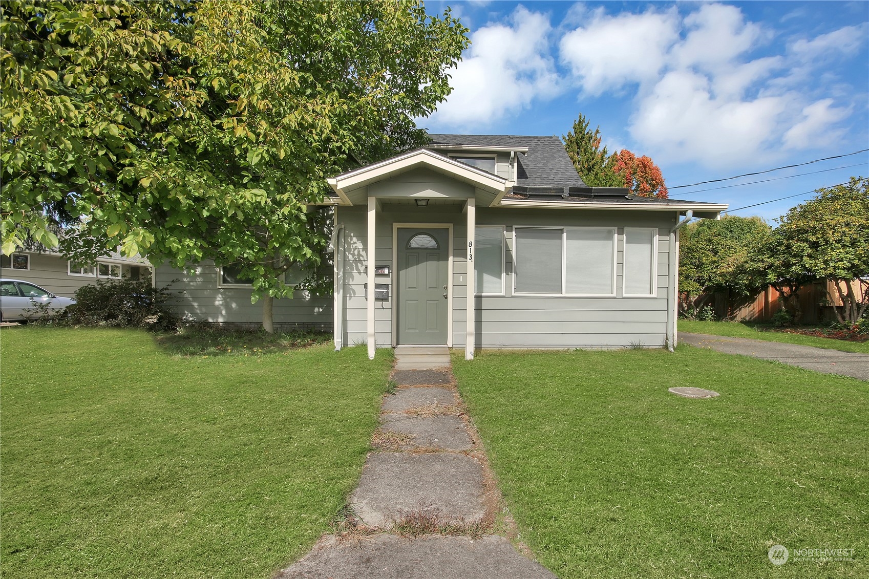 a front view of a house with a garden and yard