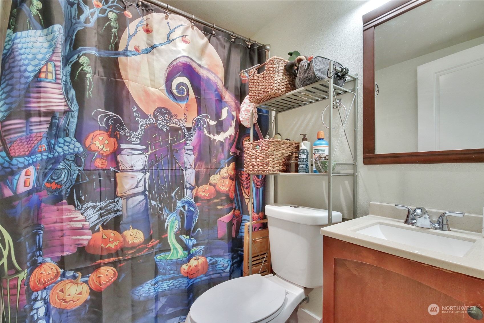 813 West Main Puyallup, WA 98371 - Photo 11 of 24 a bathroom with a sink toilet and mirror