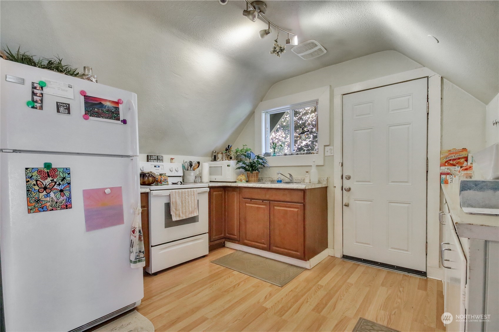 813 West Main Puyallup, WA 98371 - Photo 17 of 24 a view of kitchen with stainless steel appliances cabinets and wooden floor