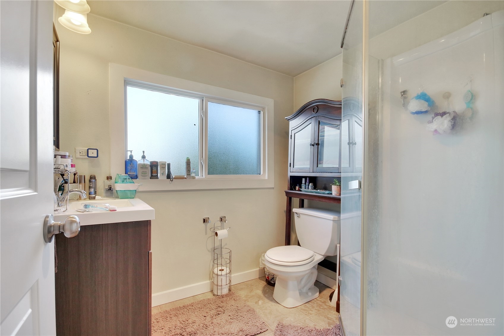 813 West Main Puyallup, WA 98371 - Photo 21 of 24 a bathroom with a sink a toilet and mirror