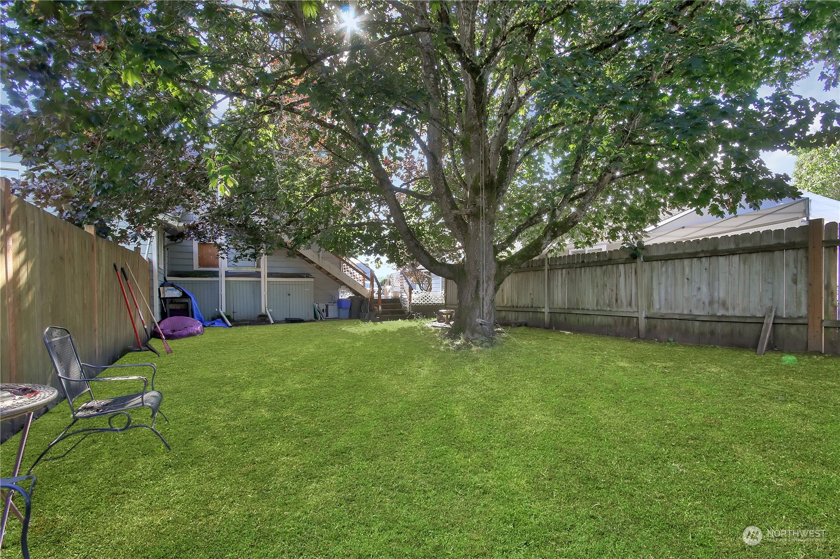 813 West Main Puyallup, WA 98371 - Photo 24 of 24 a view of a backyard with large trees and wooden fence