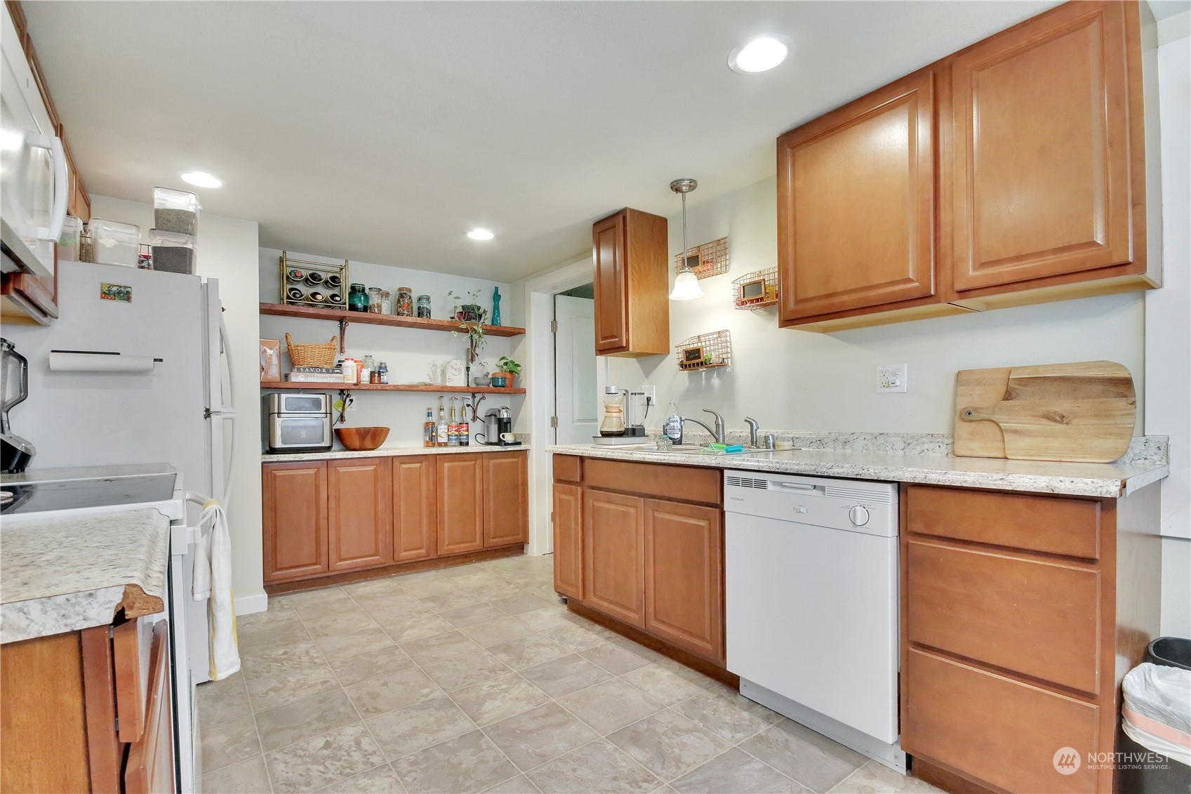 813 West Main Puyallup, WA 98371 - Photo 7 of 24 a kitchen with granite countertop white cabinets and stainless steel appliances