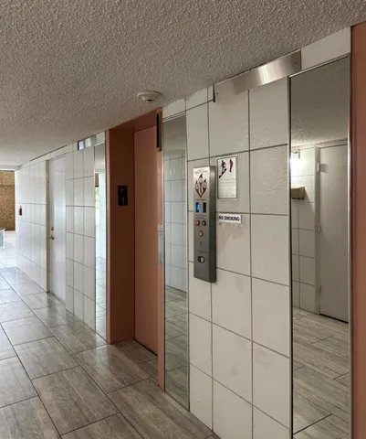 a bathroom with a shower and a glass door