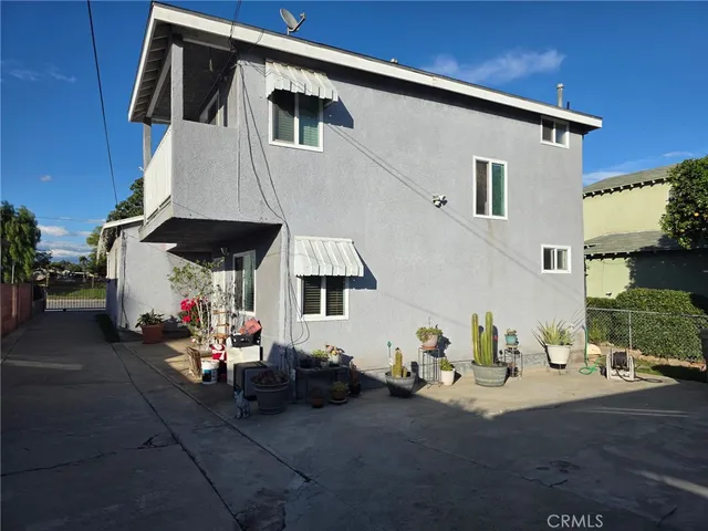 a view of a patio with table and chairs under an umbrella