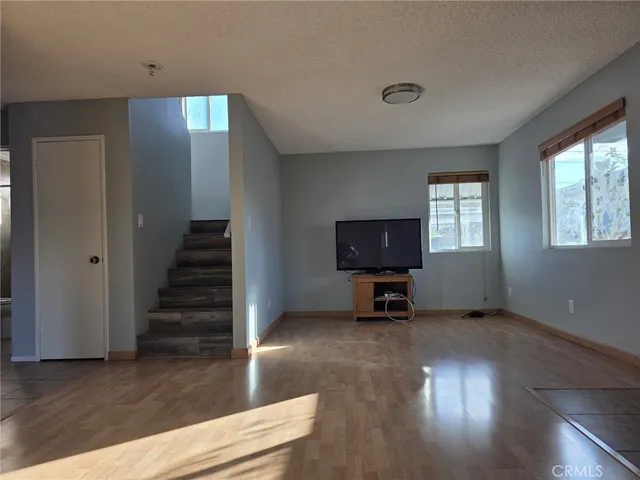 a view of a livingroom with wooden floor and a window