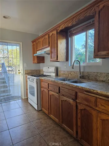 a kitchen with a sink stove and cabinets
