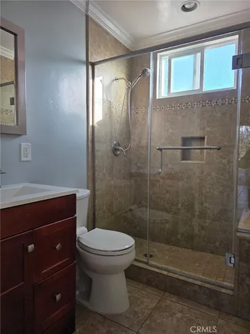 a bathroom with a shower a toilet and a sink