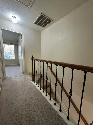 a view of a hallway with stairs