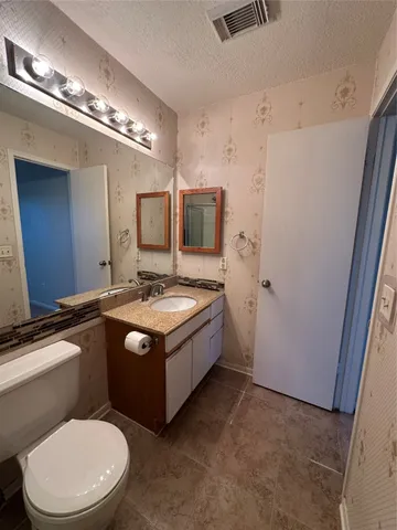 a spacious bathroom with a bathtub sink and mirror