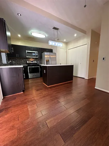 a view of kitchen with microwave and cabinets