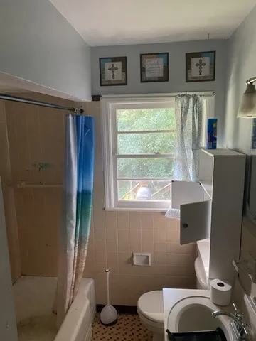 a bathroom with a toilet sink and tub