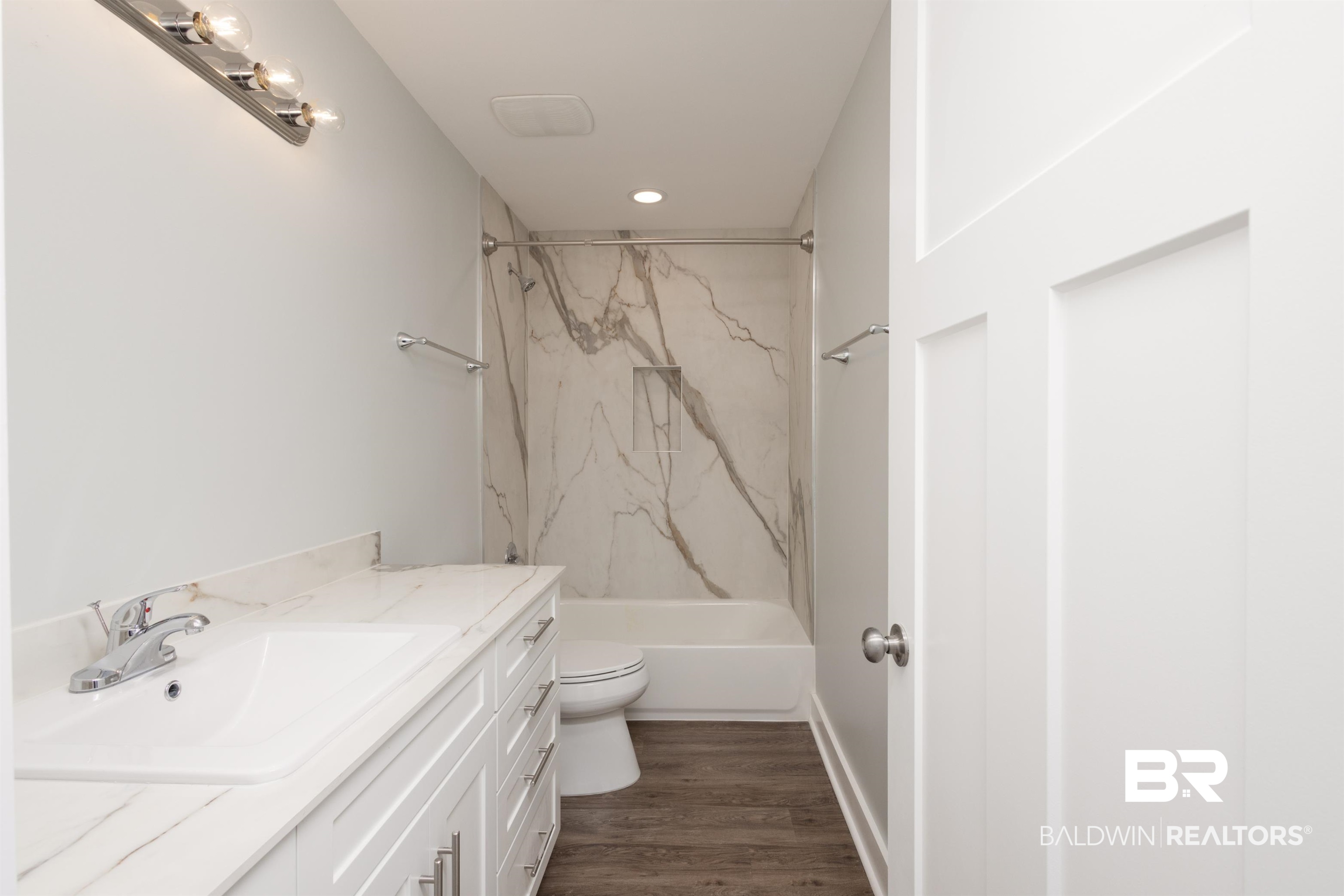 18267 Highway 98 Foley, AL 36535 - Photo 13 of 26 Full bathroom with vanity, a combined bath / shower with marble appearance, and dark wood finished floors