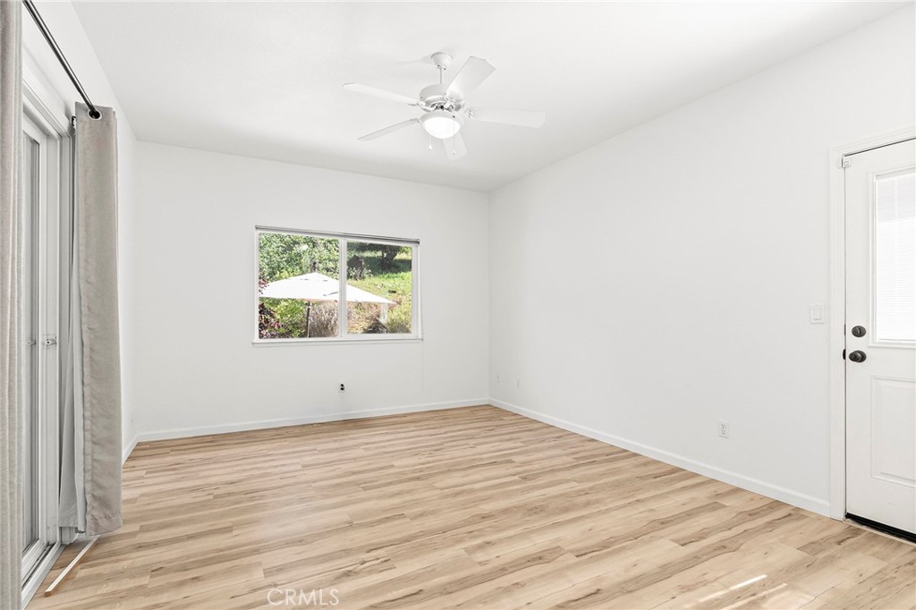 2262 Honey Run Road Chico, CA 95928 - Photo 25 of 74 a view of an empty room with wooden floor and a window