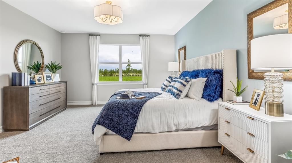 17911 Shade Tree Loop Babcock Ranch, FL 33982 - Photo 11 of 44 a living room with a bed furniture and a window