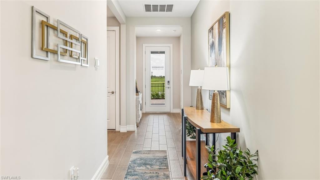 17911 Shade Tree Loop Babcock Ranch, FL 33982 - Photo 2 of 44 view of hall way with mirror