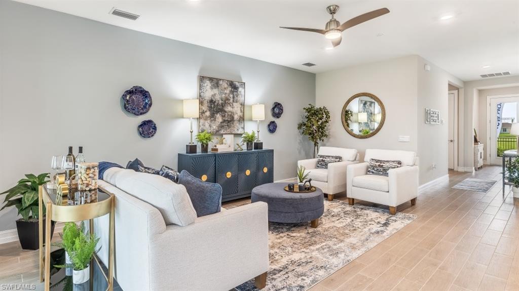 17911 Shade Tree Loop Babcock Ranch, FL 33982 - Photo 3 of 44 a living room with furniture a clock and a window