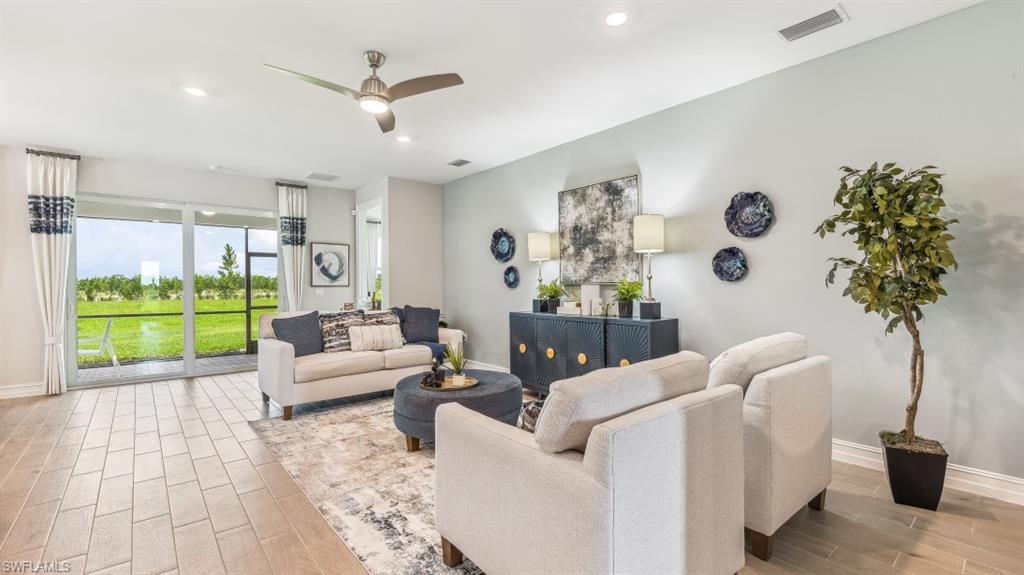 17911 Shade Tree Loop Babcock Ranch, FL 33982 - Photo 4 of 44 a living room with furniture and garden view