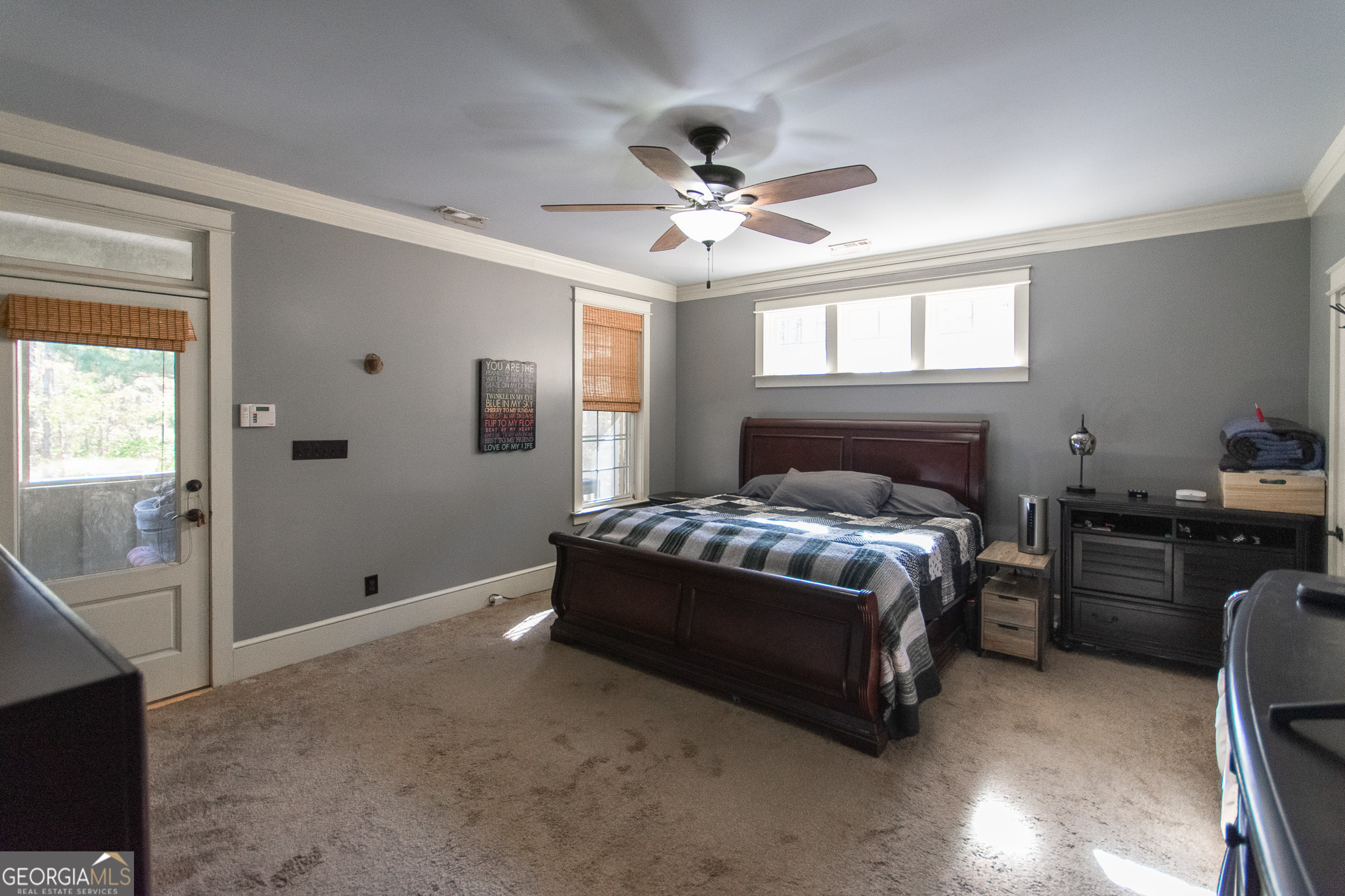 190 Carl Williams Road Senoia, GA 30276 - Photo 29 of 93 a spacious bedroom with a bed and a chandelier