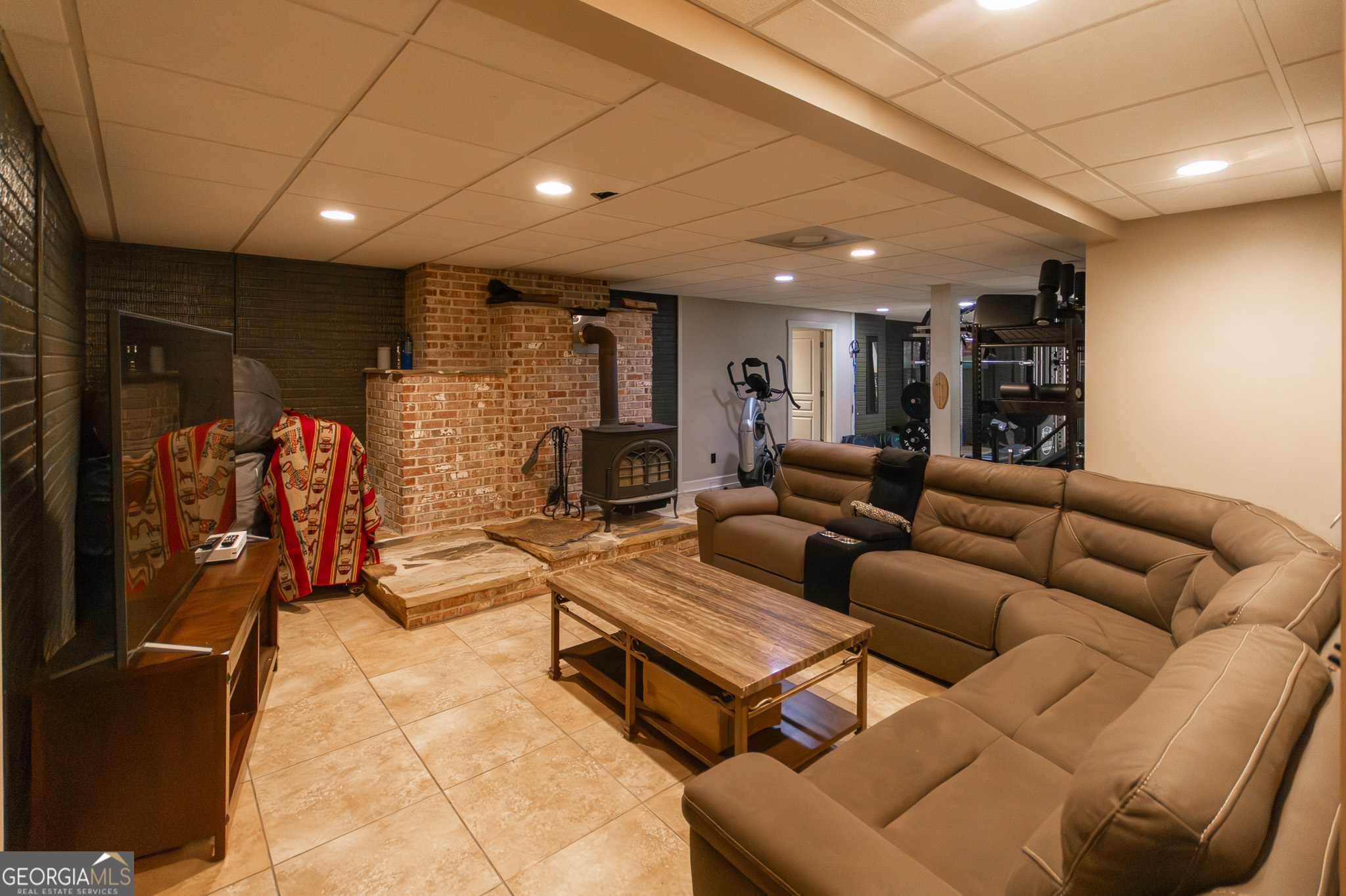190 Carl Williams Road Senoia, GA 30276 - Photo 48 of 93 a living room with furniture a lamp and a fireplace