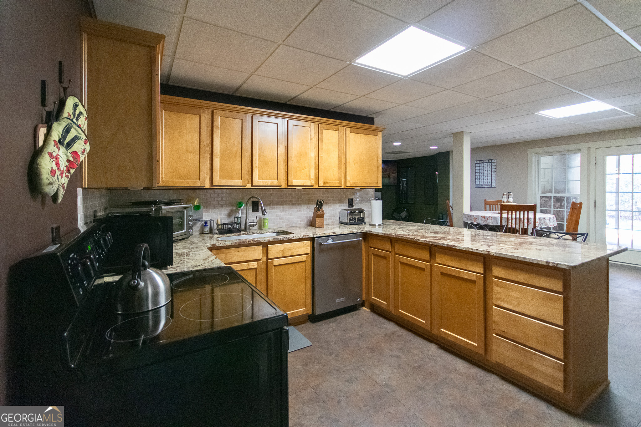 190 Carl Williams Road Senoia, GA 30276 - Photo 54 of 93 a kitchen with granite countertop sink stainless steel appliances and cabinets