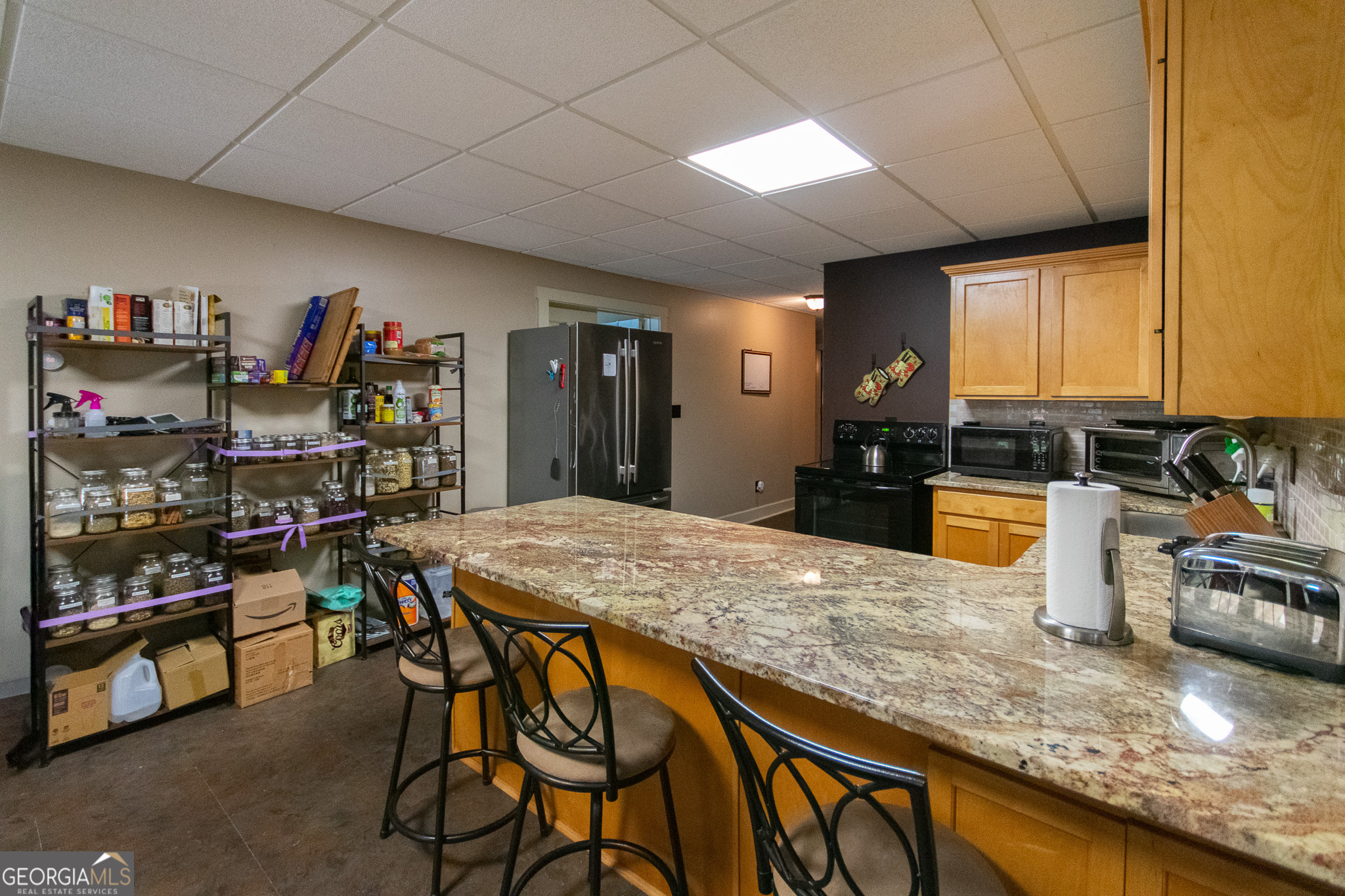 190 Carl Williams Road Senoia, GA 30276 - Photo 56 of 93 a kitchen with stainless steel appliances granite countertop sink stove and cabinets