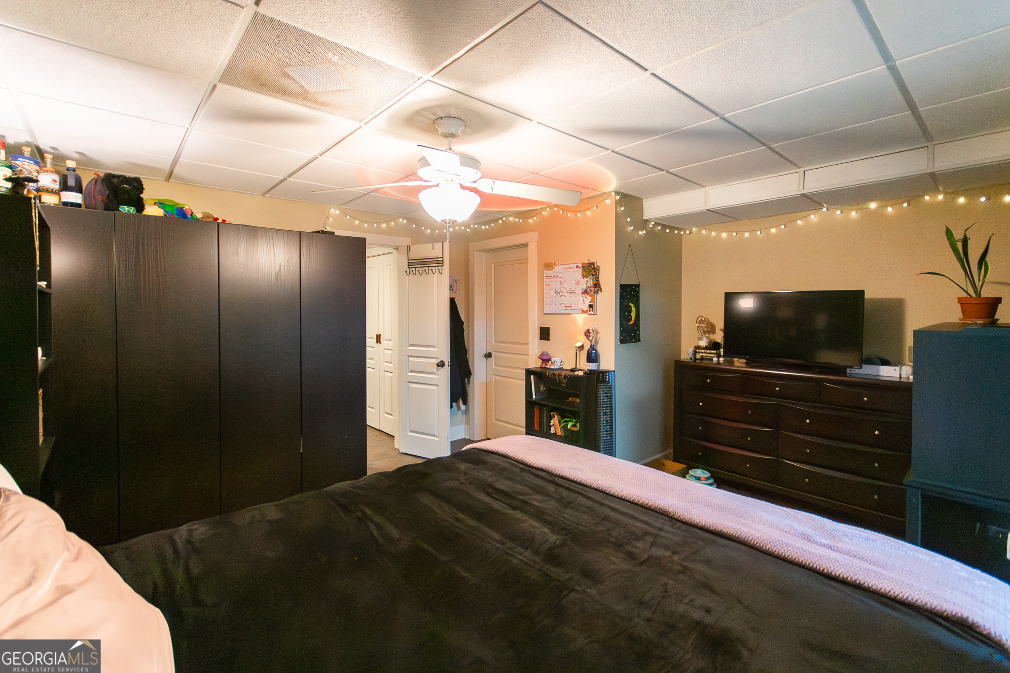 190 Carl Williams Road Senoia, GA 30276 - Photo 63 of 93 a bedroom with a bed and a flat tv screen on wall
