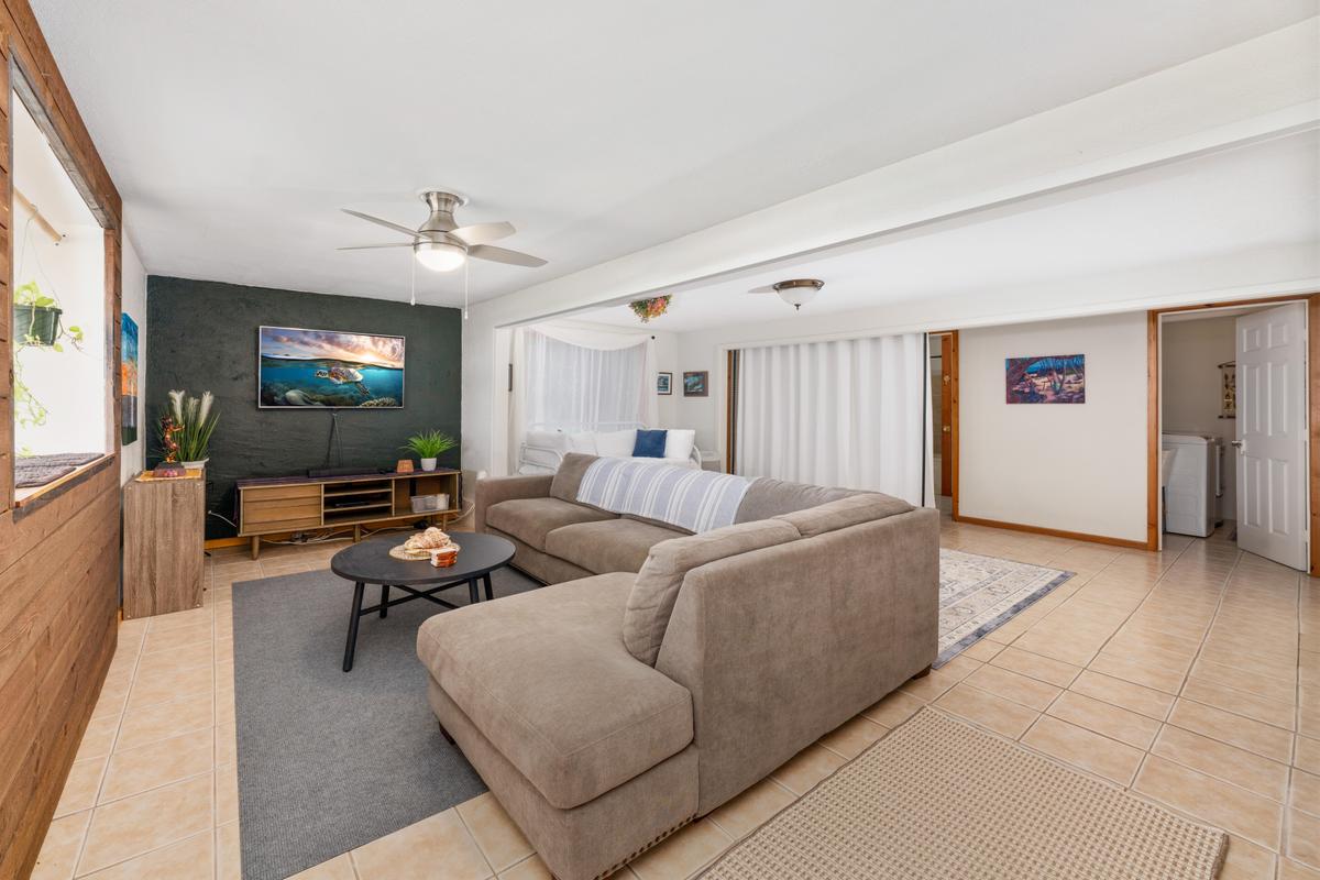 85-4563 Hawaii Belt Road Captain Cook, HI 96704 - Photo 23 of 30 a living room with furniture and a flat screen tv