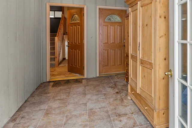a view of a hallway with wooden floor and entryway