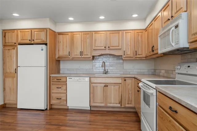 a kitchen with stainless steel appliances granite countertop a refrigerator sink and cabinets