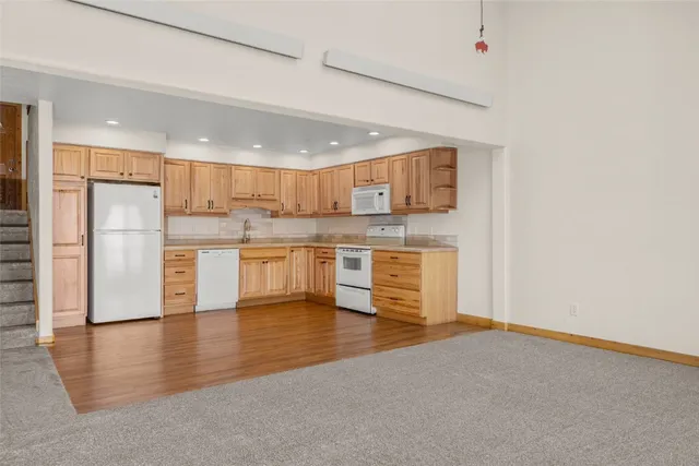a kitchen with stainless steel appliances a refrigerator and a stove top oven