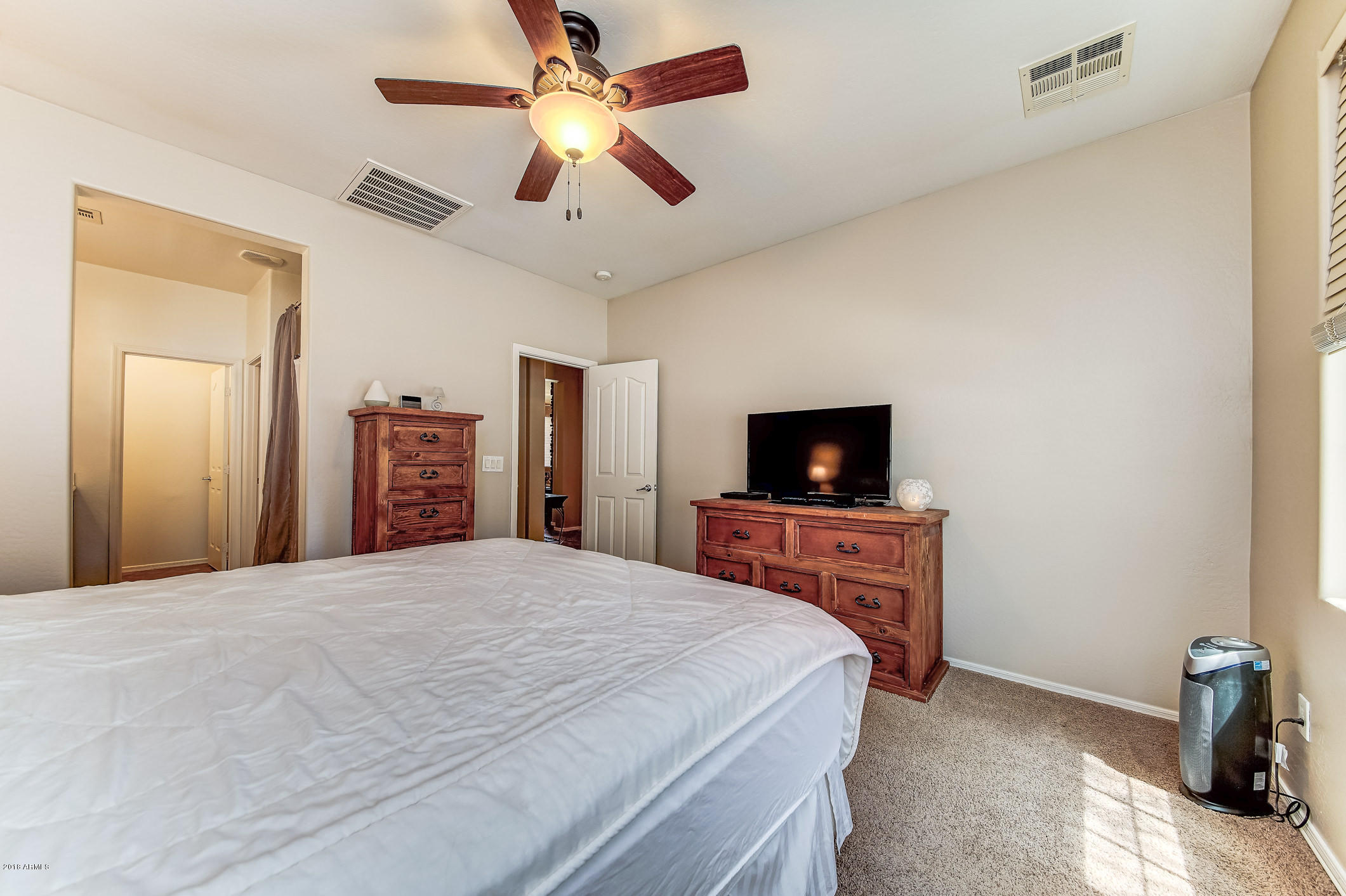 1714 South Rochester Drive Gilbert, AZ 85295 - Photo 23 of 51 a bedroom with a bed and a flat screen tv
