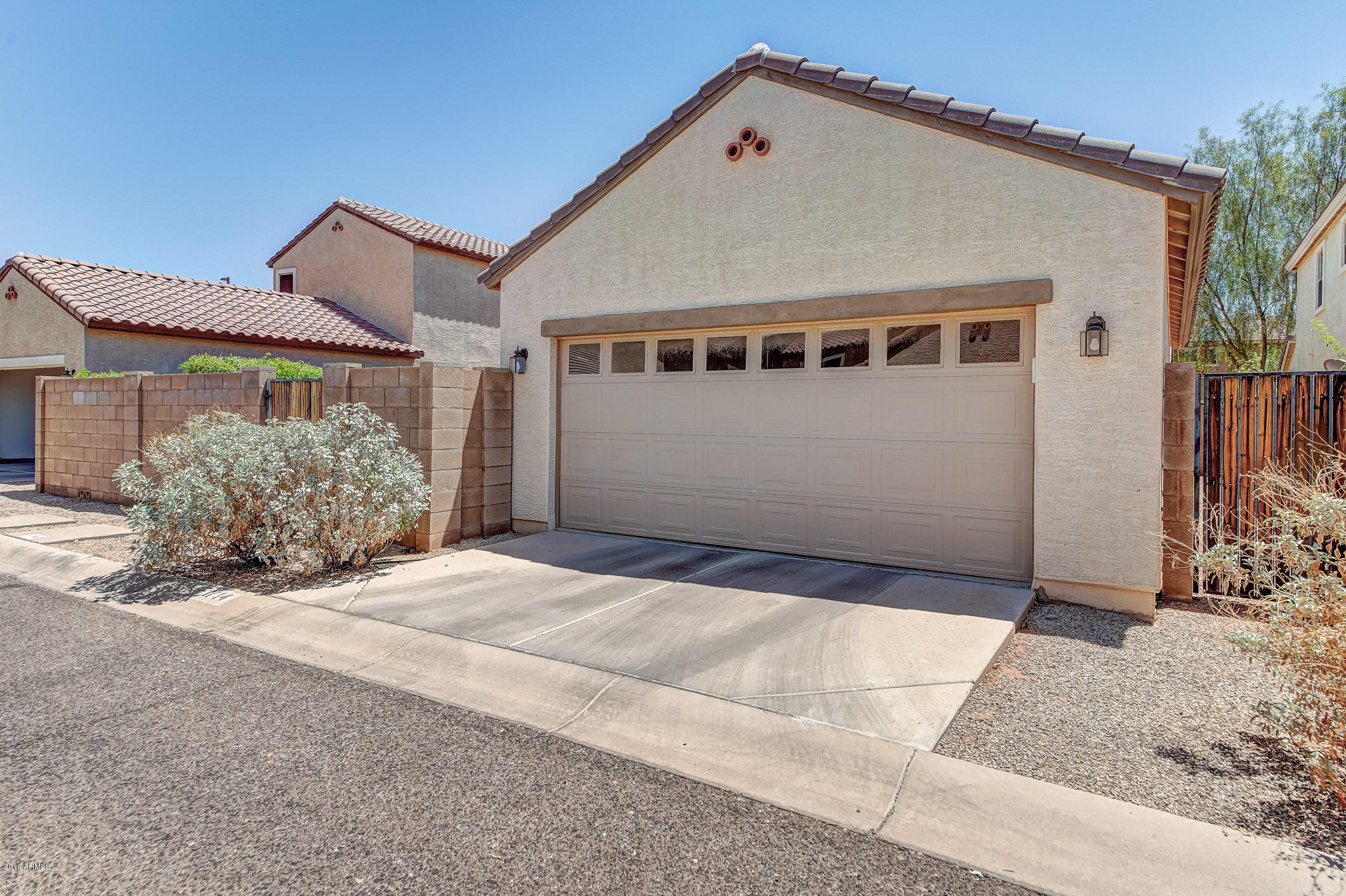 1714 South Rochester Drive Gilbert, AZ 85295 - Photo 36 of 51 a front view of a house with a yard and garage
