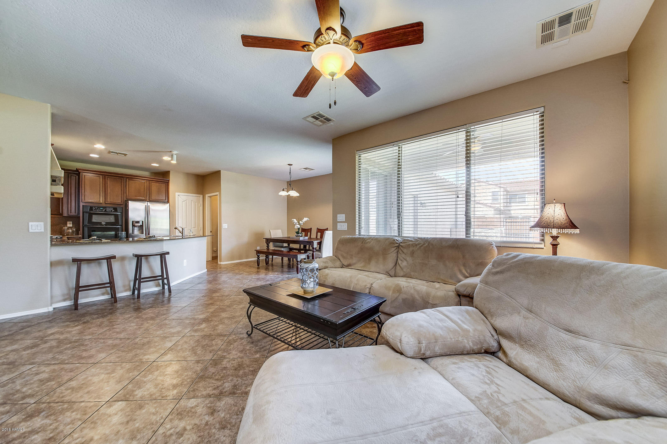 1714 South Rochester Drive Gilbert, AZ 85295 - Photo 10 of 51 a living room with furniture and a large window